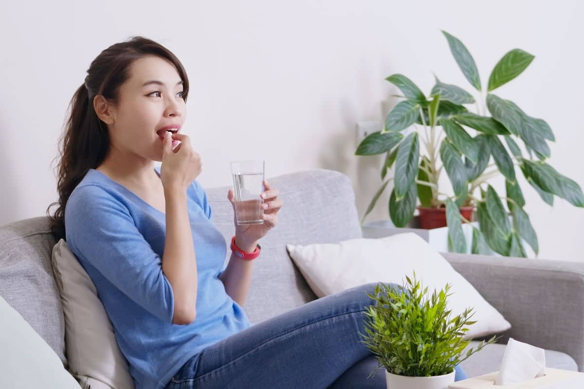 Wanita mengonsumsi obat oral