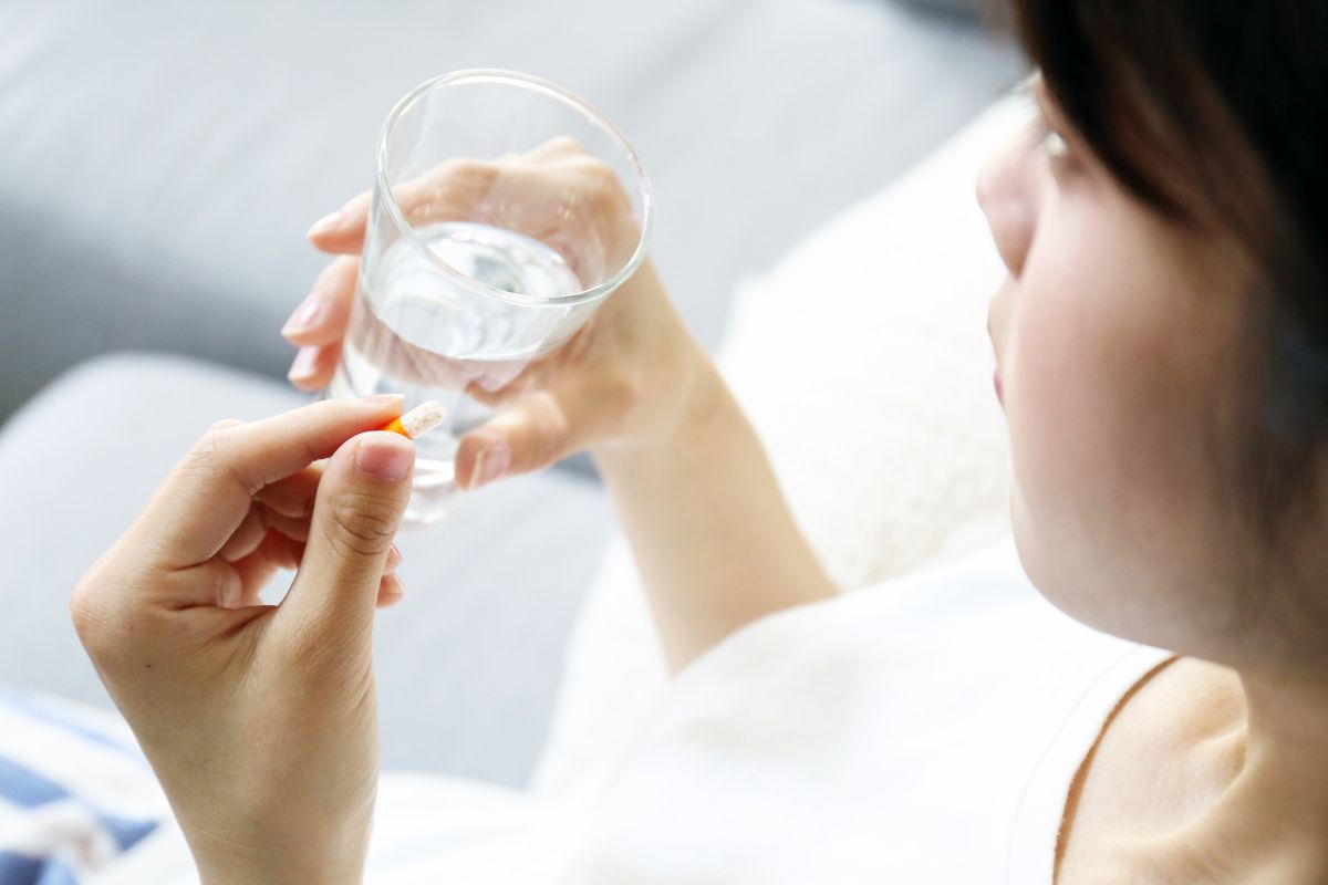 Seorang wanita sedang mengonsumsi obat oral
