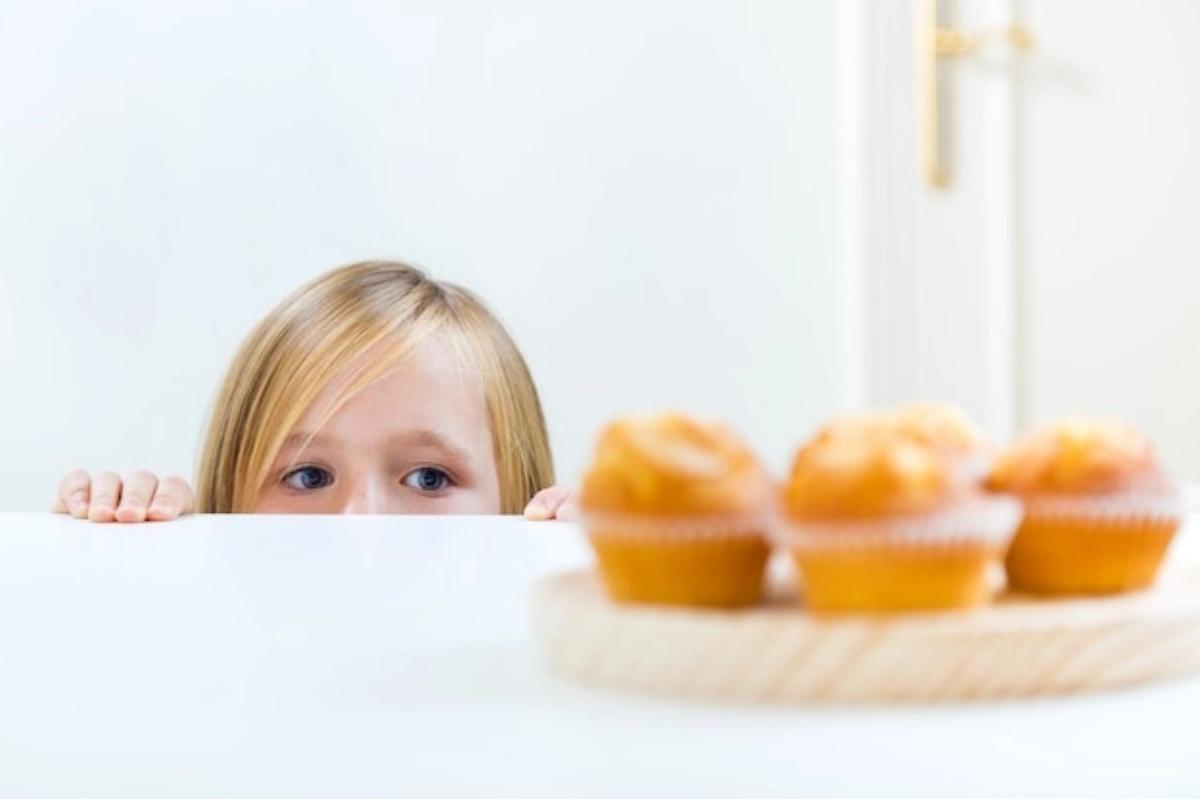 Anak mengintip makanan di atas meja
